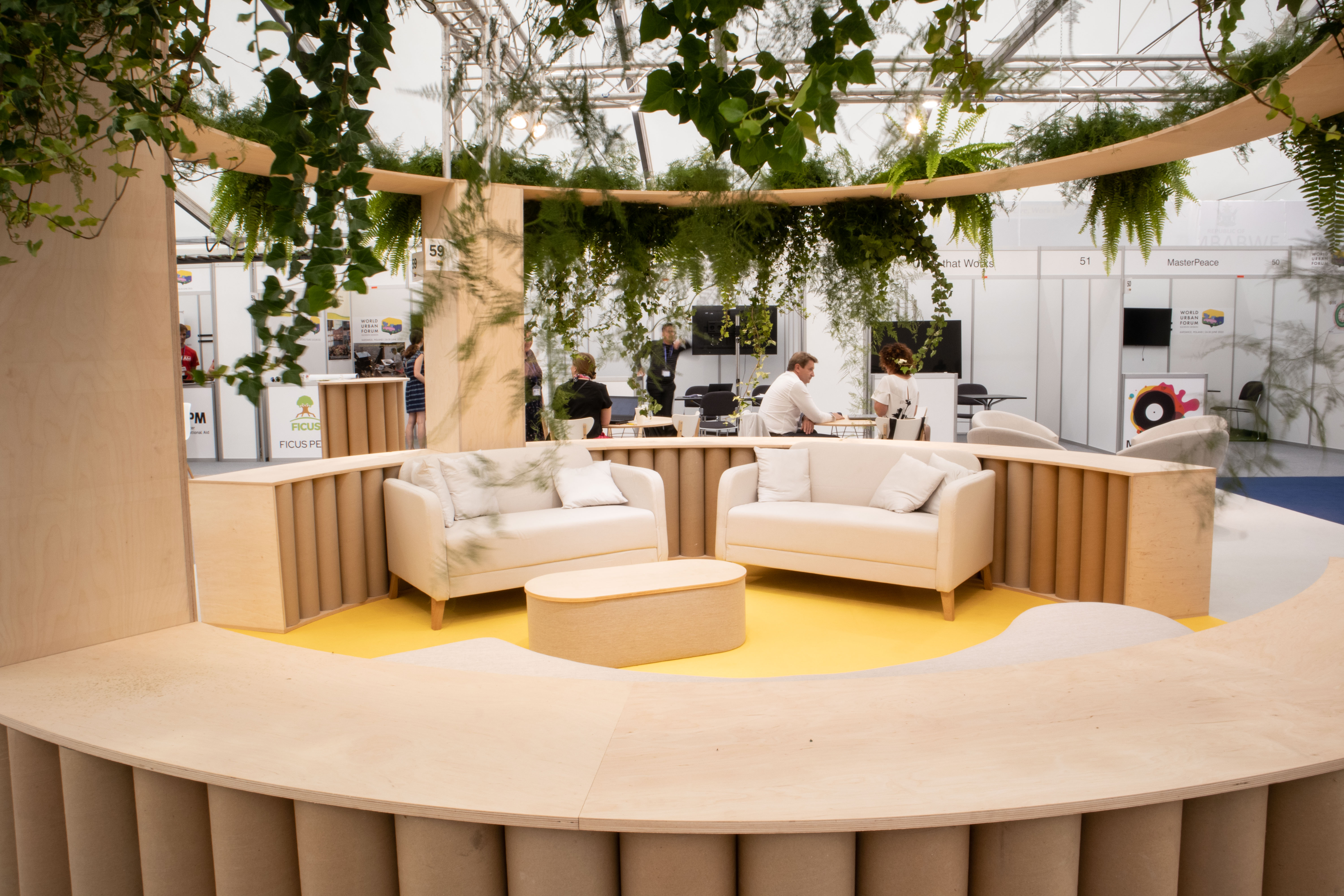 Photo of the stand, view of the rest area. Armchairs surrounded by plants.