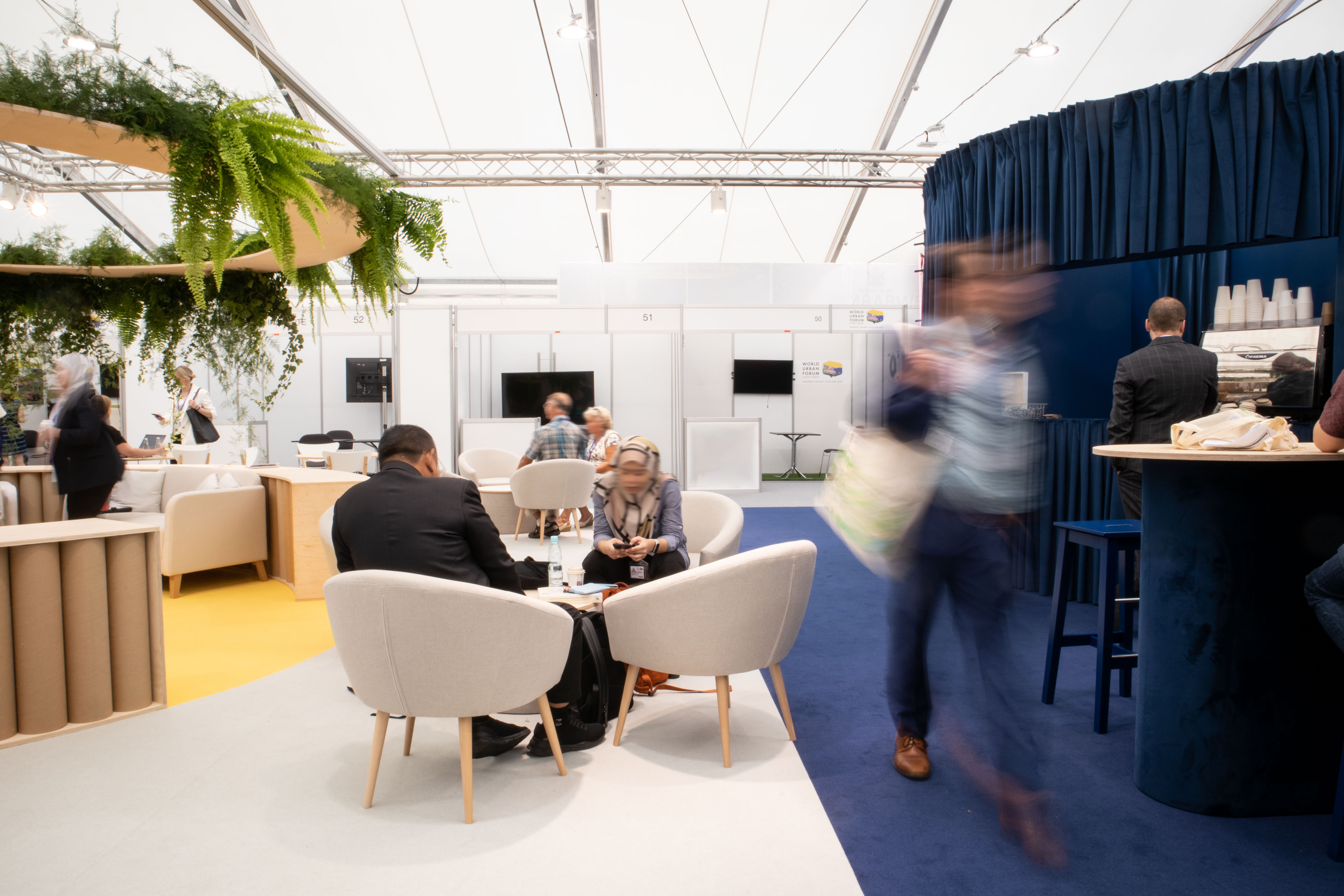 Photo of the stand, view of the networking zone and the bar.
